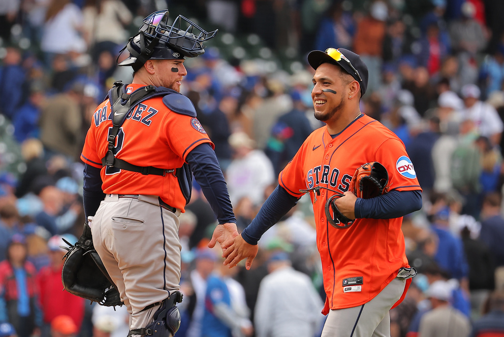 Houston Astros' Christian Vazquez, left, celebrates with Isaac Paredes, right, after a baseball game against the Chicago Cubs on Friday, May 22, 2026, in Chicago. (AP Photo/Melissa Tamez)