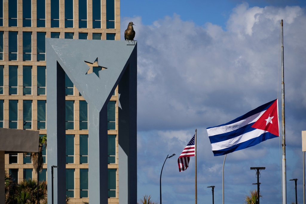 The Cuban flag flies at half-mast at the Anti-Imperialist Tribune near the U.S. embassy in Havana, Cuba, Monday, Jan. 5, 2026, in memory of Cubans who died two days before in Caracas, Venezuela during the capture of Venezuelan President Nicolas Maduro by U.S. forces. (AP Photo/Ramon Espinosa)