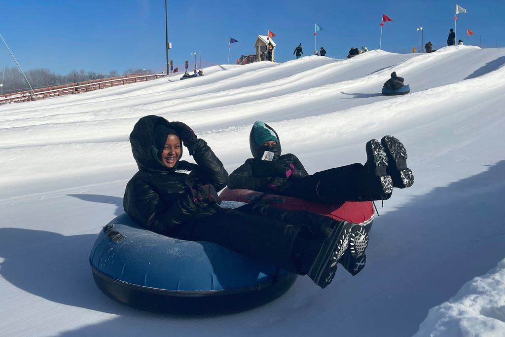 FILE - Nawal Hirsi, right, part of the Twin Cities' Somali community, goes snow tubing with her family as part of a group promoting outdoors activities by Muslim women, at Elm Creek Park Reserve in Maple Grove, Minn., on Jan. 4, 2025. (AP Photo/Giovanna Dell'Orto, File)
