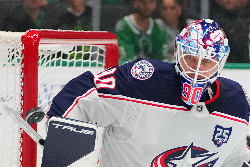 Columbus Blue Jackets goaltender Elvis Merzlikins deflects a shot by the Dallas Stars during the first period of an NHL hockey game Tuesday, Oct. 21, 2025, in Dallas. (AP Photo/Julio Cortez)