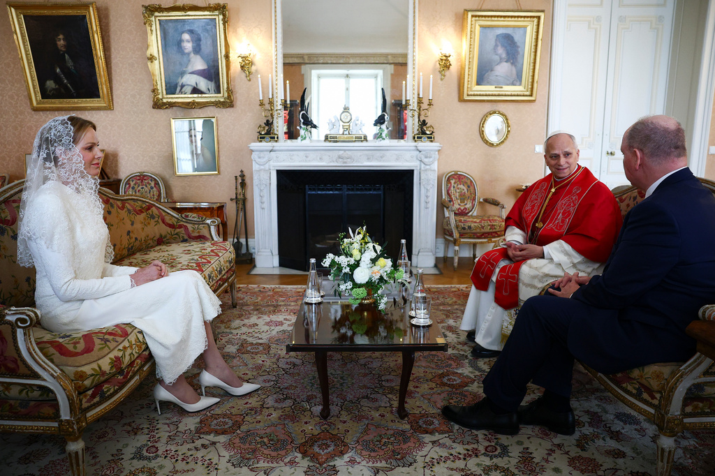 Princess Charlene of Monaco, left, and Prince Albert II of Monaco, right, meet Pope Leo XIV at the Prince's Palace during Leo XIV's one-day pastoral visit to the Principality of Monaco, Saturday, March 28, 2026. (Guglielmo Mangiapane/Pool Photo via AP)