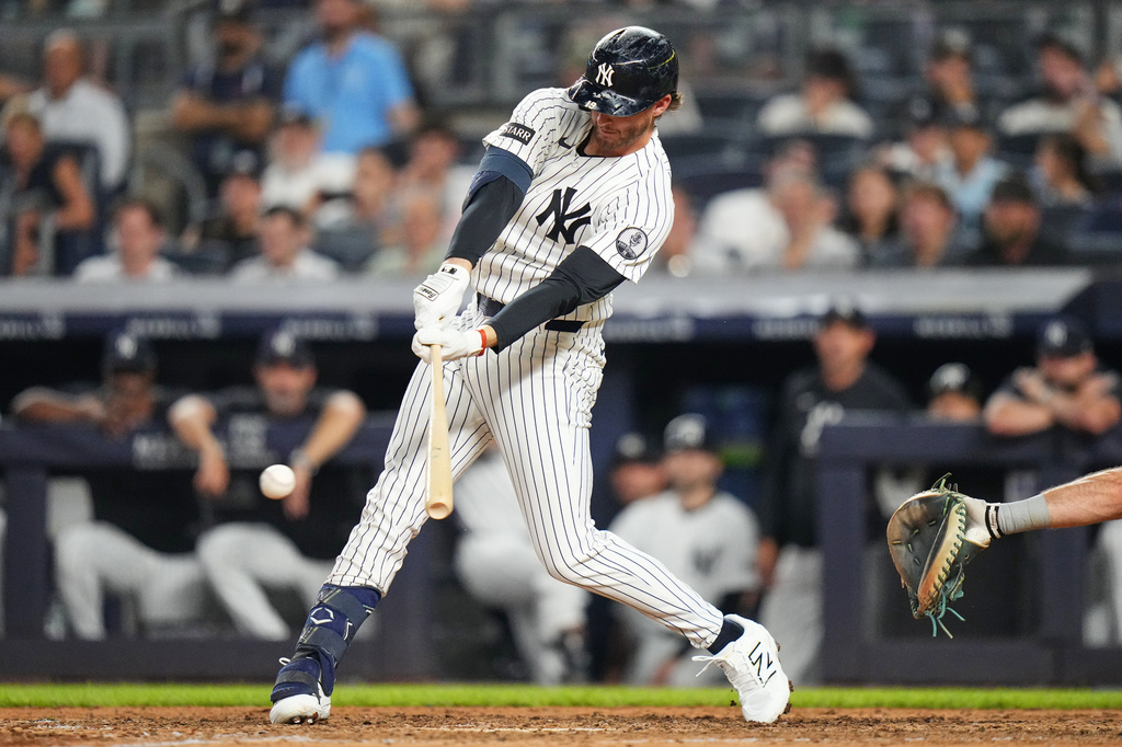 New York Yankees' Ryan McMahon hits a two-run RBI single during the seventh inning of a baseball game against the Seattle Mariners Tuesday, Aug. 11, 2026, in New York. (AP Photo/Frank Franklin II)