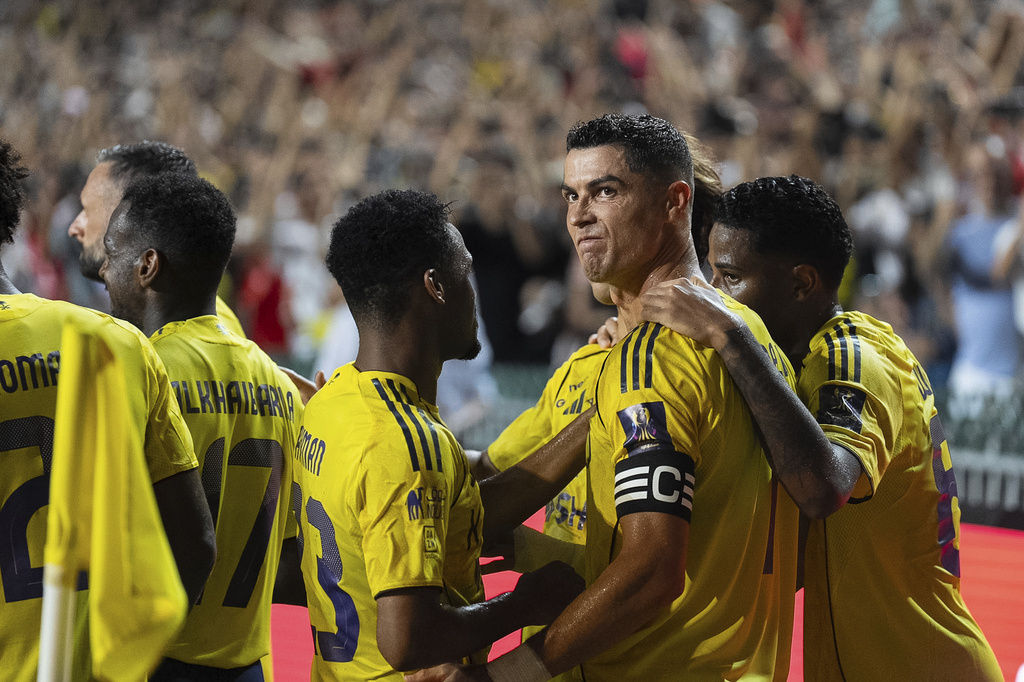 Al Nassr's Cristiano Ronaldo celebrates with teammates after scoring a goal with a penalty kick during the Saudi Super Cup final soccer match between Al Ahli and Al Nassr at the Hong Kong Stadium in Hong Kong, Saturday, Aug. 23, 2025. (AP Photo/Chan Long Hei)
