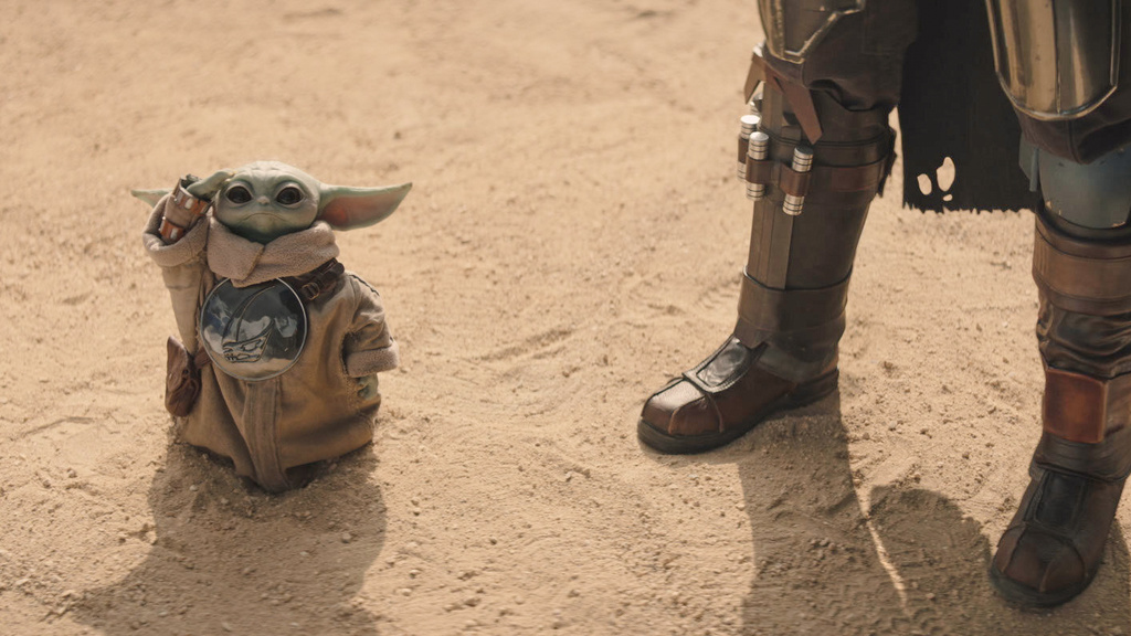 This image released by Disney shows The Mandalorian, portrayed by Pedro Pascal, right, and Grogu in a scene from Lucasfilm's "Star Wars: The Mandalorian and Grogu." (Lucasfilm Ltd. - Disney via AP)