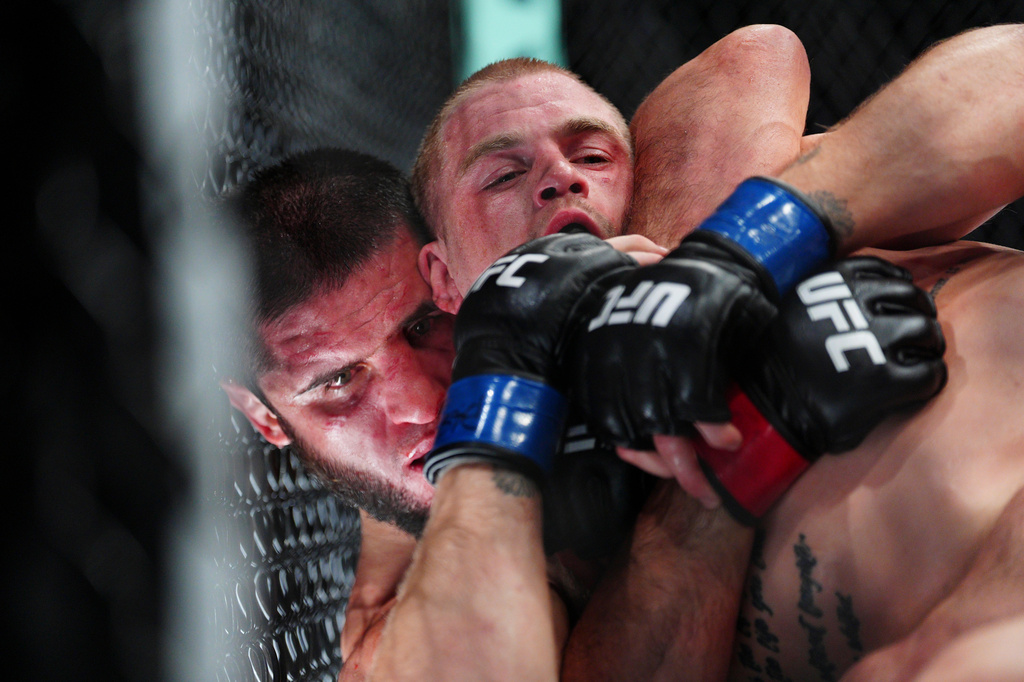 Islam Makhachev, left, and Ian Machado Garry battle in a welterweight title fight at the UFC 330 mixed martial arts event Sunday, Aug. 16, 2026, in Philadelphia. (AP Photo/Derik Hamilton)