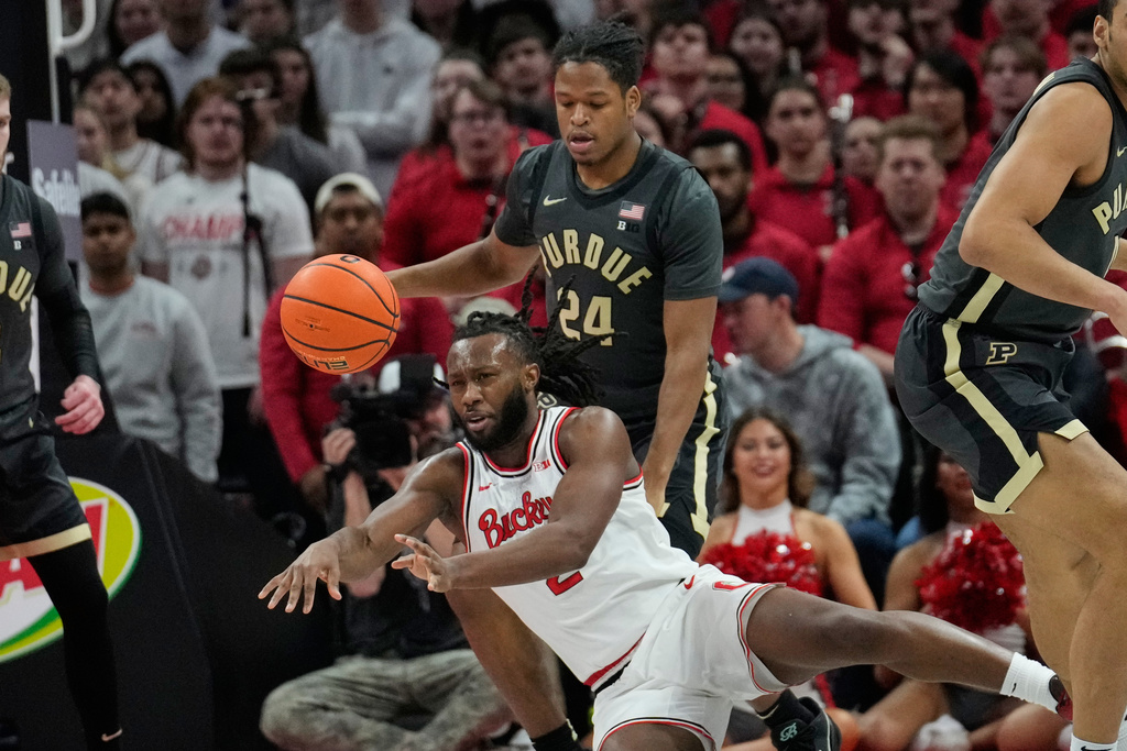 Ohio State guard Bruce Thornton, front, passes in front of Purdue guard Gicarri Harris (24) in the first half of an NCAA college basketball game Sunday, March 1, 2026, in Columbus, Ohio. (AP Photo/Sue Ogrocki)