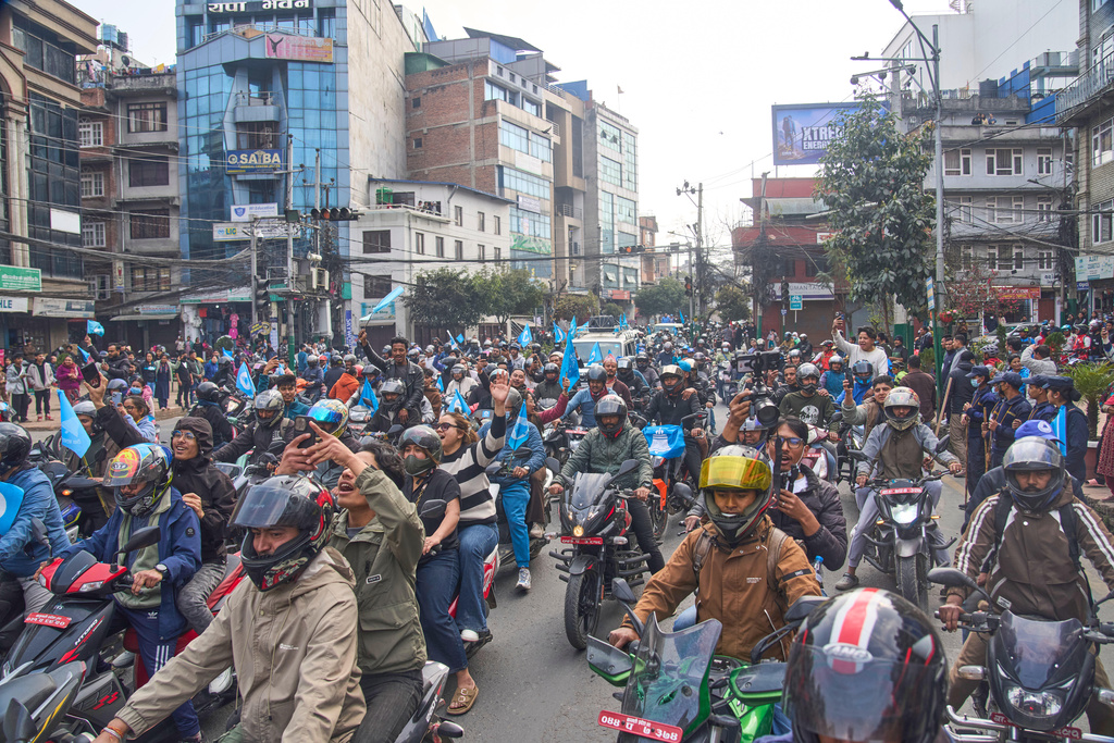 Rastriya Swatantra Party supporters on motorcycles join prime ministerial candidate Balendra Shah, the former mayor of Kathmandu, during an election campaign rally in Lalitpur, Nepal, Saturday, Feb. 28, 2026. (AP Photo/Niranjan Shrestha)