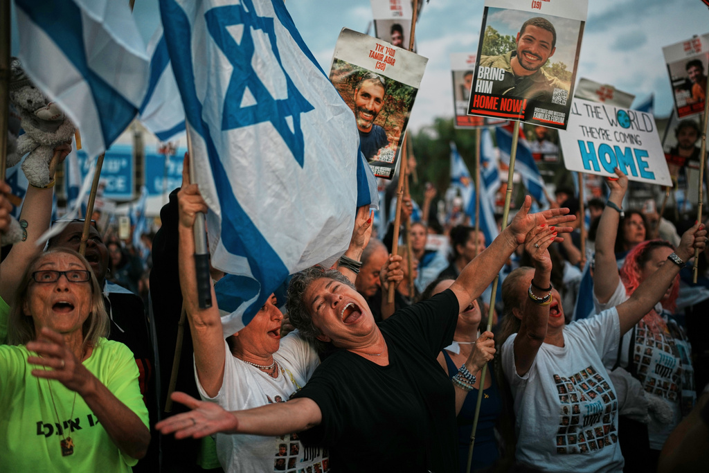 People gather at a plaza known as the hostages square in Tel Aviv, Israel, Monday, Oct. 13, 2025 prior to the release of Israeli hostages held in Gaza. (AP Photo/Emilio Morenatti)