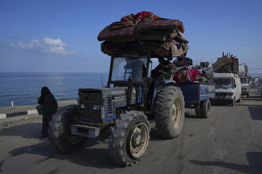 Displaced Palestinians carry their belongings as they flee northern Gaza along the coastal road toward the south, as Israel announced an expanded operation in Gaza City, Tuesday, Sept. 16, 2025. (AP Photo/Abdel Kareem Hana)