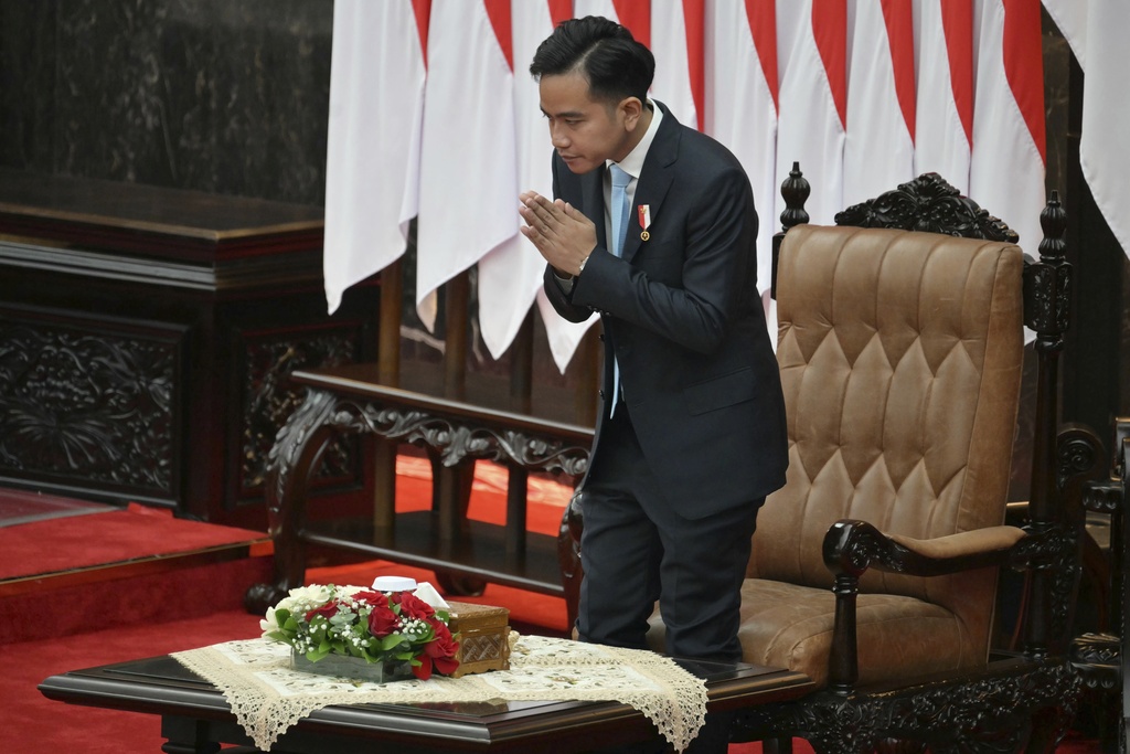 Indonesian Vice President Gibran Rakabuming Raka gestures before President Prabowo Subianto delivers his annual State of the Nation Address, ahead of the country's Independence Day in Jakarta Friday, Aug. 15, 2025. (Bay Ismoyo/Pool Photo via AP)