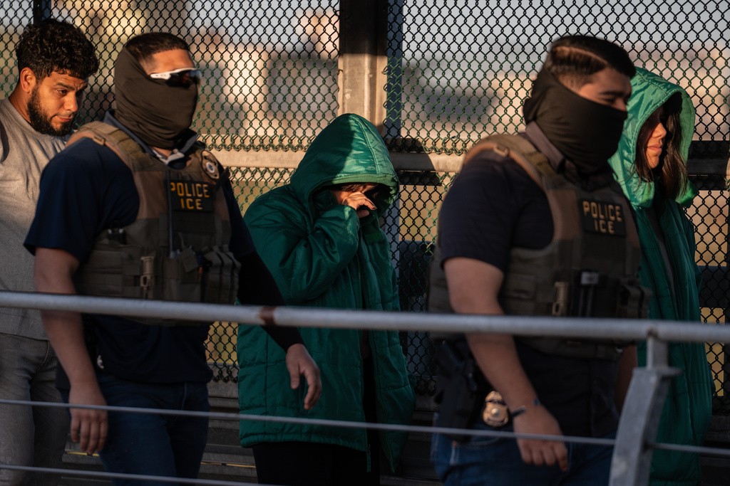 A group of undocumented migrants is deported by U.S. Immigration and Customs Enforcement agents across the McAllen–Hidalgo–Reynosa International Bridge in McAllen, Texas, Friday, March 13, 2026. Dozens of migrants from countries including Cuba, Venezuela, Haiti, China, Guatemala and El Salvador were handed over to Mexican authorities. (AP Photo/Felix Marquez)