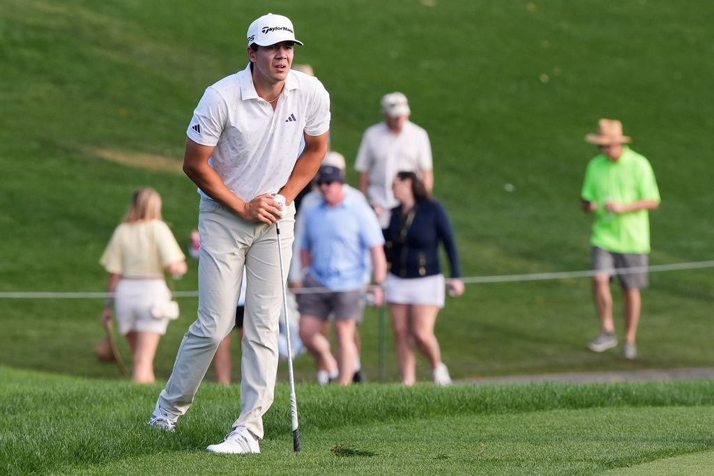 Michael Thorbjornsen watches his drive from the rough of the 18th fairway during the third round of The Players Championship golf tournament Saturday, March 14, 2026, in Ponte Vedra Beach, Fla. (AP Photo/Gerald Herbert)
