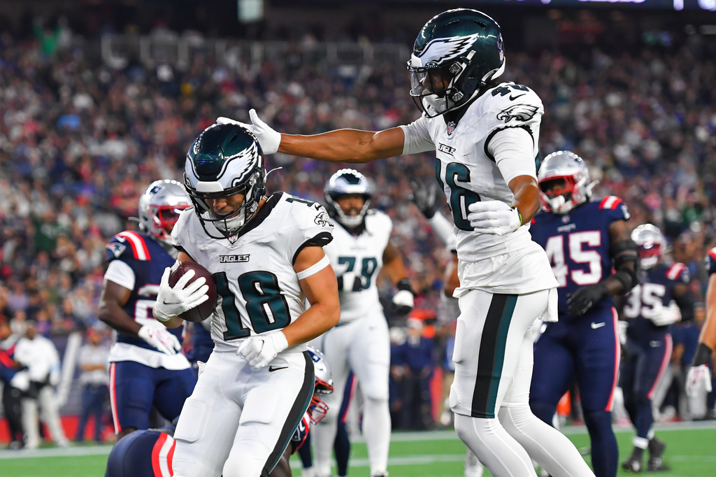 Philadelphia Eagles wide receiver Britain Covey (18) scores a touchdown as wide receiver Samori Toure celebrates against the New England Patriots during the first half of an NFL preseason football game, Saturday, Aug. 22, 2026, in Foxborough, Mass. (AP Photo/Steven Senne)