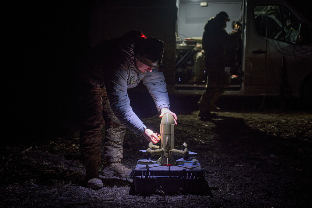 A Ukrainian soldier prepares an interceptor drone during Russia's aerial attack in an undisclosed location in Ukraine, on Dec. 13, 2025. (AP Photo/Efrem Lukatsky)