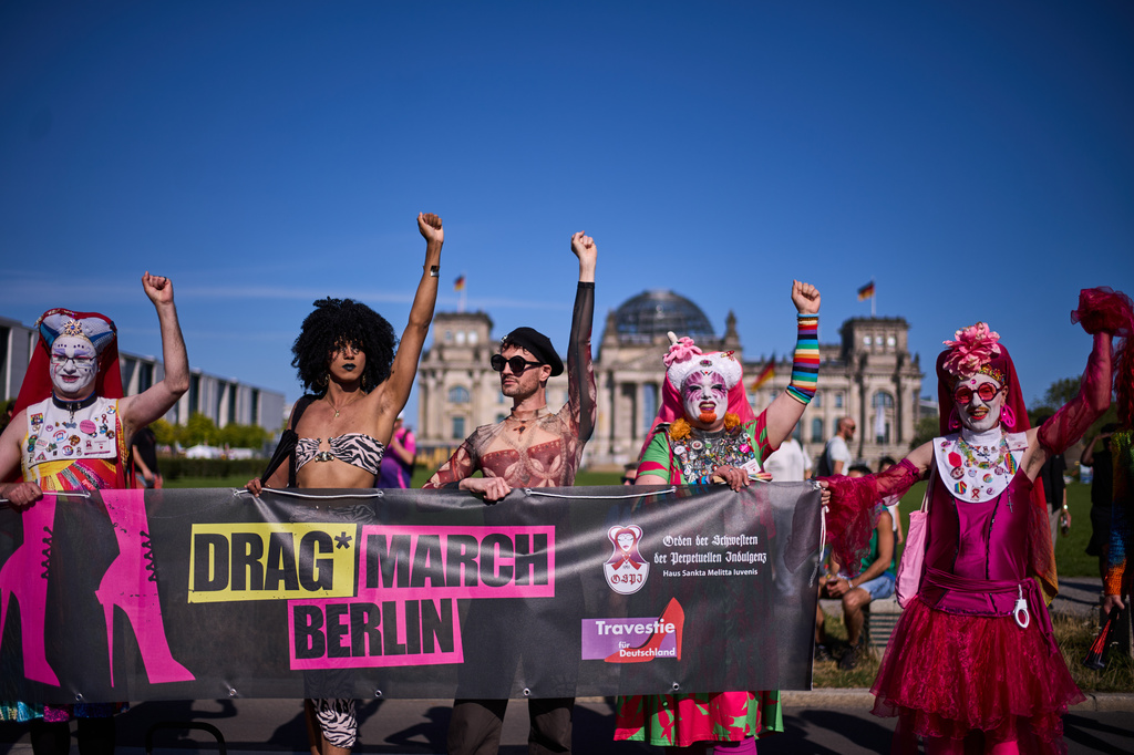 Sister Pia, left, Sister Daphne, second right, and Sister Clementia of the German chapter OSPI of the Sisters of Perpetual Indulgence, SPI, pose in front of the German parliament building the Reichstag Building during the first Drag March on the eve of the Pride Parade in Berlin, Germany, Friday, July 24, 2026. (AP Photo/Markus Schreiber)