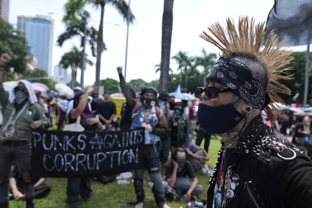 Protesters in punk costumes join an anti-corruption rally in Manila, Philippines on Sunday, Sept. 21, 2025. (AP Photo/Aaron Favila)