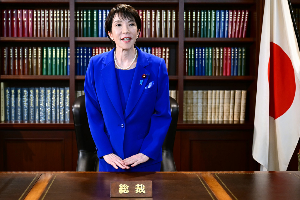 FILE - Sanae Takaichi, the newly-elected leader of Japan's ruling party, the Liberal Democratic Party (LDP), gestures as she leaves the party leader's office after the LDP leadership election in Tokyo, on Oct. 4, 2025. (Yuichi Yamazaki/Pool Photo via AP, File)