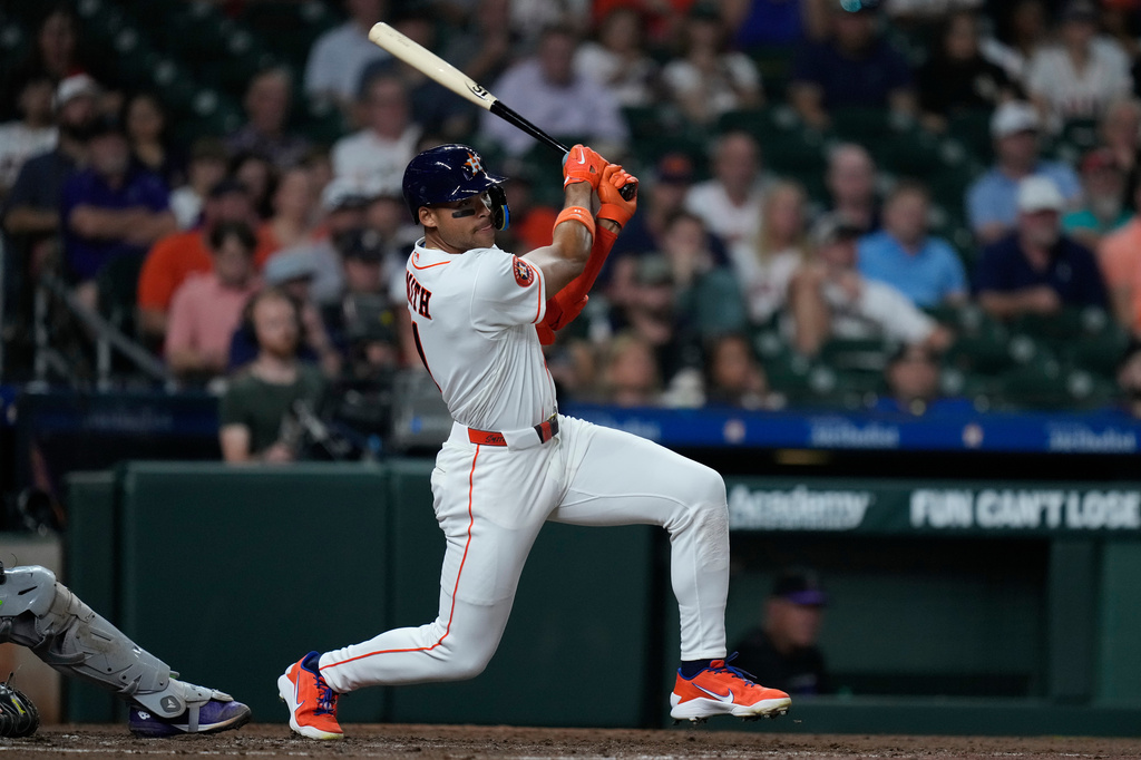 Houston Astros' Cam Smith hits an RBI single during the third inning of a baseball game against the Colorado Rockies, Tuesday, April 14, 2026, in Houston. (AP Photo/Kevin M. Cox)