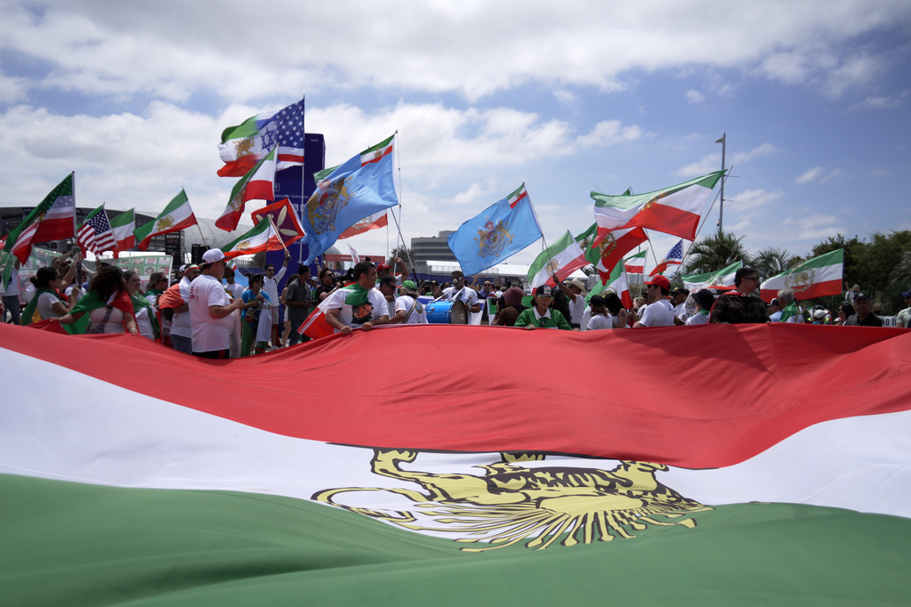 Demonstrators unfurl a large pre-revolutionary Iranian flag outside of the World Cup Group G soccer match between Belgium and Iran in Inglewood, Calif., near Los Angeles, Sunday, June 21, 2026. (AP Photo/Ty Oneil)
