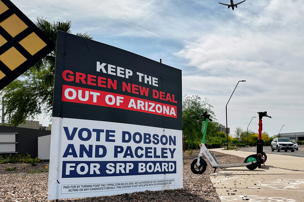 A sign supporting candidates for the Salt River Project board sits next to an intersection Monday, March 30, 2026 in Tempe, Ariz. (AP Photo/Jonathan J. Cooper)