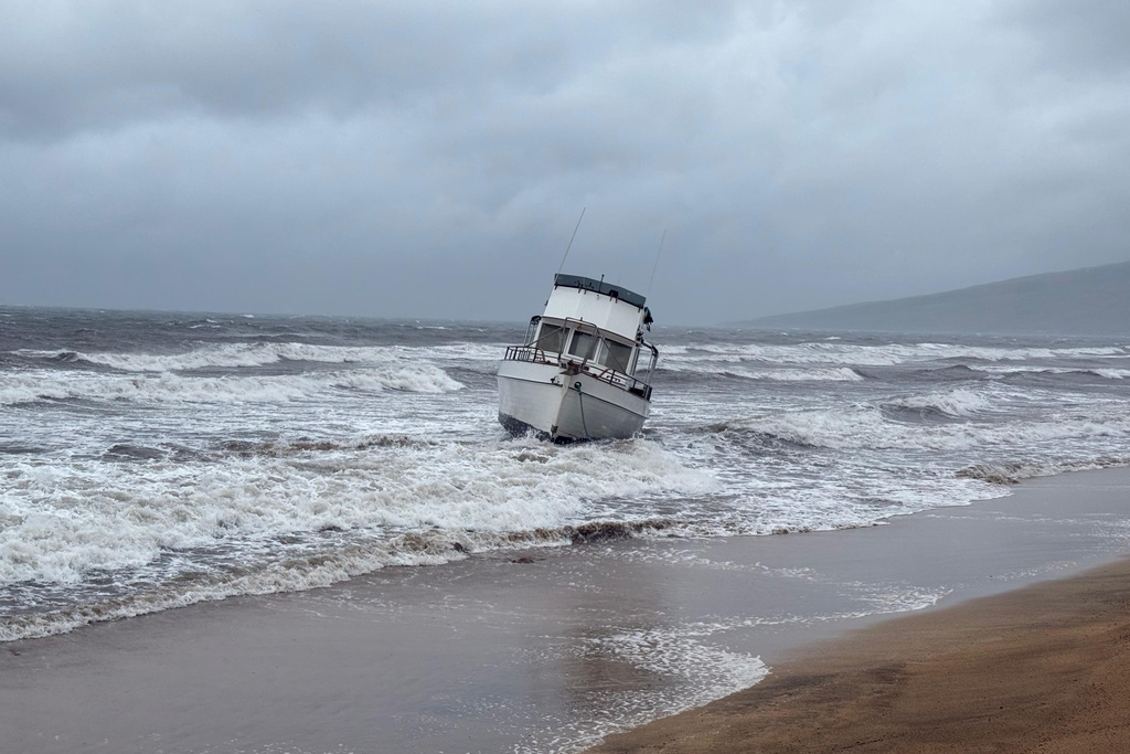 In this photo provided by Maui County, a boat is grounded on a beach off Kihei, Hawaii, during heavy rain on Friday, March 13, 2026. (Maui County via AP)