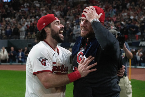 Cleveland Guardians' Austin Hedges celebrates with assistant pitching coach Brad Goldberg after securing an American League playoff spot at the end of a baseball game against the Texas Rangers, Saturday, Sept. 27, 2025, in Cleveland. (AP Photo/Phil Long) Cleveland Guardians' Austin Hedges celebrates with assistant pitching coach Brad Goldberg after securing an American League playoff spot at the end of a baseball game against the Texas Rangers, Saturday, Sept. 27, 2025, in Cleveland. (AP Photo/Phil Long)