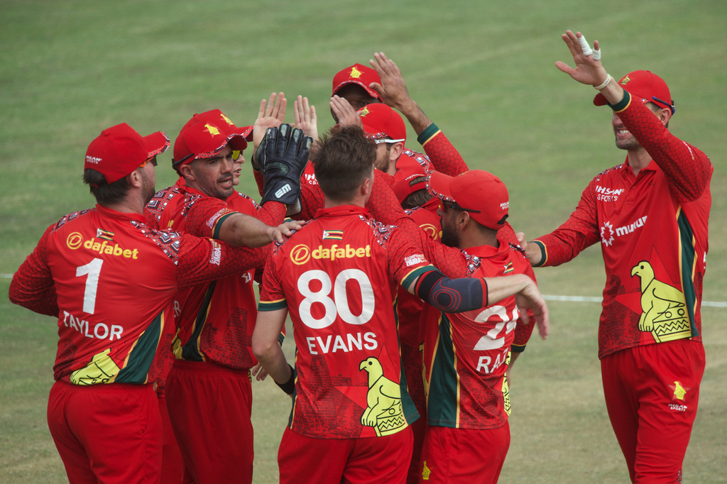 Zimbabwe's bowler Bradley Evans, center, celebrates with his teammates after taking a wicket during the third one day international cricket match between Zimbabwe and Australia in Harare, Zimbabwe, Sunday, Sept. 20, 2026. (AP Photo/Wonder Mashura)