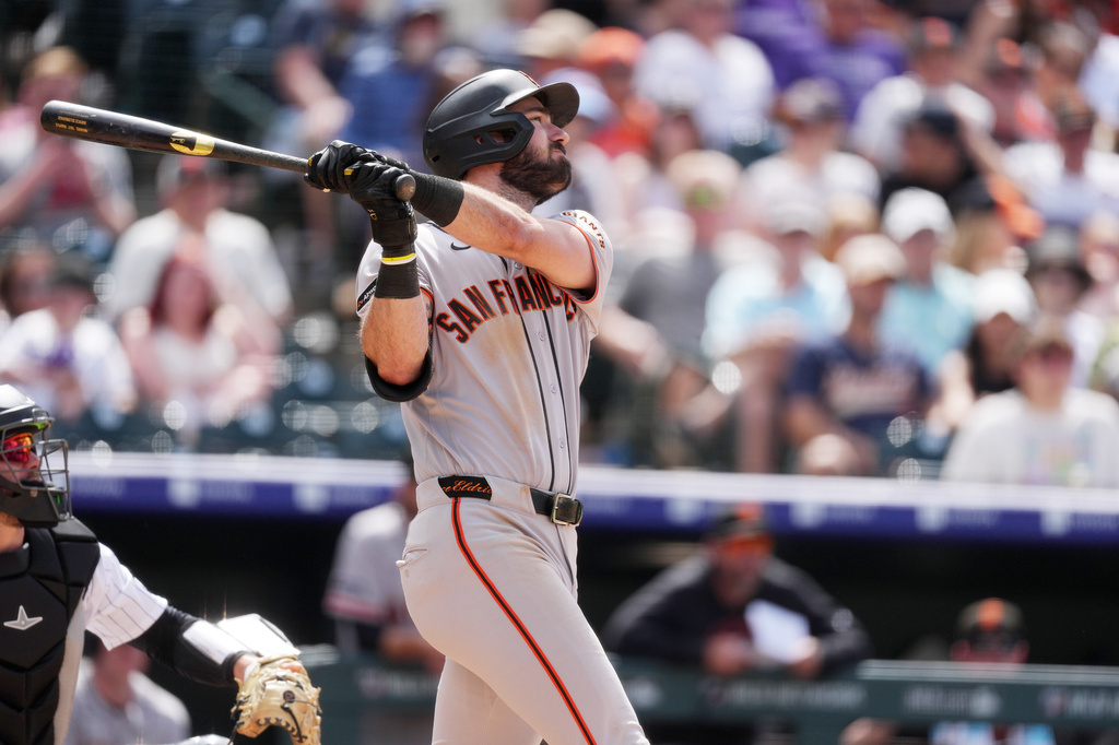 San Francisco Giants' Bryce Eldridge follows the flight of solo home run off Colorado Rockies relief pitcher Keegan Thompson in the sixth inning of a baseball game Sunday, May 31, 2026, in Denver. (AP Photo/David Zalubowski)