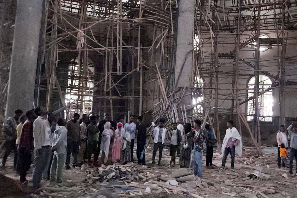 Worshippers stand inside the Menjar Shenkora Arerti Mariam Church under construction that collapsed in Arerti, Amhara region of northern Ethiopia, on Wednesday, Oct. 1, 2025. (AP Photo/Samuel Getachew)