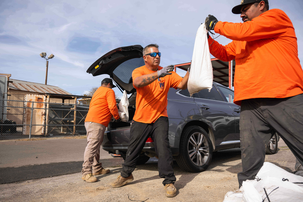 Los Angeles County Public Works crew loads sandbags for residents on Monday, Dec. 22, 2025 in Altadena, Calif., in preparation for the upcoming storm. (Sarah Reingewirtz/The Orange County Register via AP)