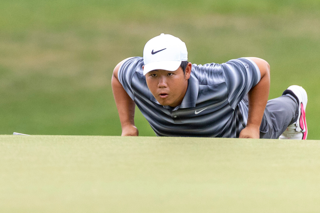Dylan Wu lies down for a better angle during the second round of the Valero Texas Open golf tournament in San Antonio, Friday, April 3, 2026. (Andrew J. Whitaker/The San Antonio Express-News via AP)