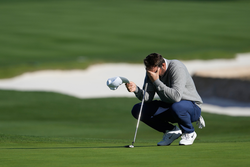 Scottie Scheffler reacts before putting on the 18th green at Pebble Beach Golf Links during the first round of the AT&T Pebble Beach Pro-Am golf tournament in Pebble Beach, Calif., Thursday, Feb. 12, 2026. (AP Photo/Godofredo A. Vásquez)