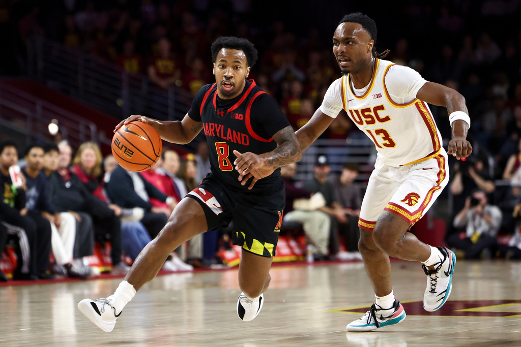 Maryland guard David Coit (8) drives against Southern California guard Kam Woods (13) during the first half of an NCAA college basketball game, Tuesday, Jan. 13, 2026, in Los Angeles. (AP Photo/Jessie Alcheh)