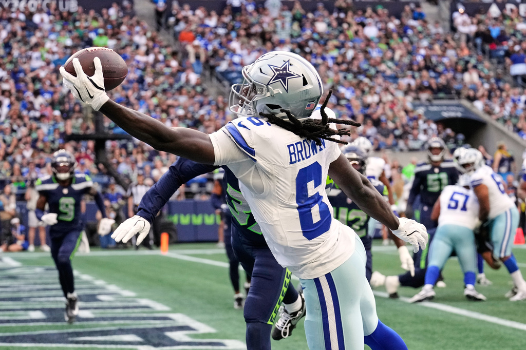 Dallas Cowboys wide receiver Camden Brown (6) catches a touchdown pass in front of Seattle Seahawks cornerback Michael Dansby, rear, in the second half of an NFL preseason football game, Saturday, Aug. 15, 2026, in Seattle. (AP Photo/Stephen Brashear)