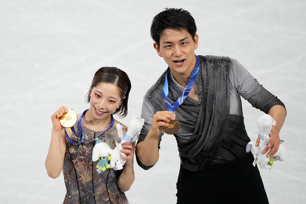 FILE -Gold medalists Riku Miura and Ryuichi Kihara of Japan receive their medals after the pairs figure skating long program at the 2026 Winter Olympics, in Milan, Italy, Monday, Feb. 16, 2026. (AP Photo/Natacha Pisarenko, File)
