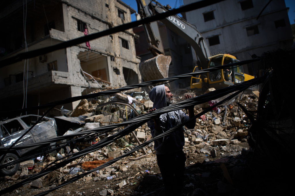 A man works at the site of Sunday's Israeli strike on a building in Beirut's Jnah neighborhood, Lebanon, Monday, April 6, 2026. (AP Photo/Emilio Morenatti)