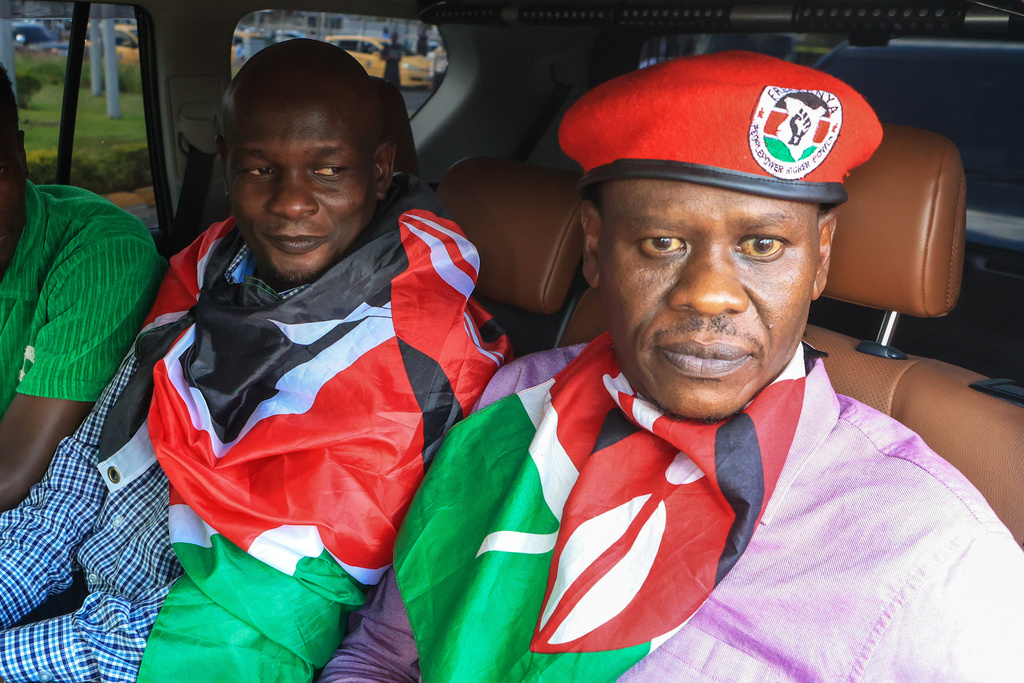 Kenyan human rights activists Nicholas Oyoo, left, and Bob Njagi, right, after their release from detention in Uganda arrive at Jomo Kenyatta International Airport (JKIA) in Nairobi, Kenya, Saturday, Nov. 9, 2025. (AP Photo/Andrew Kasuku)