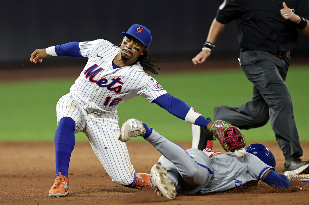 Kansas City Royals' Tyler Tolbert safely steals second base as New York Mets shortstop Francisco Lindor (12) drops the ball during the fifth inning of a baseball game Tuesday, July 7, 2026, in New York. (AP Photo/Adam Hunger)