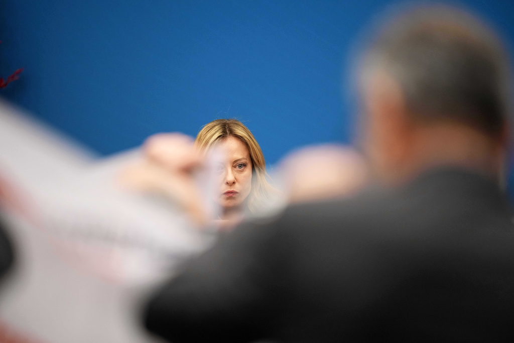 Italian journalists display banners demanding the renewal of their employment contracts in front of Italian Prime Minister Giorgia Meloni during her annual start-of-the-year press conference in the press room at the Lower Chamber, in Rome, Friday, Jan. 9, 2026. (AP Photo/Andrew Medichini)