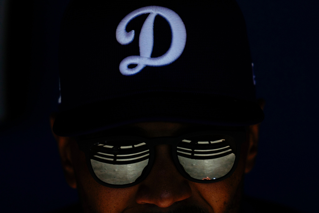 Los Angeles Dodgers shortstop Mookie Betts sits in the dugout during a spring training baseball game against the Chicago Cubs, Feb. 20, 2025, in Phoenix. (AP Photo/Ashley Landis, File)