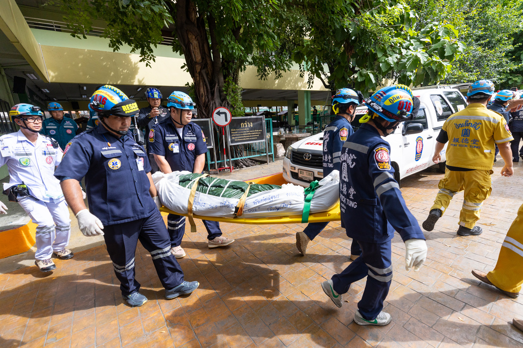 The body of a victim of a school shooting is carried out of a school in Thailand's Nonthaburi province, Friday, Aug. 7, 2026. (AP Photo/Wason Wanichakorn)