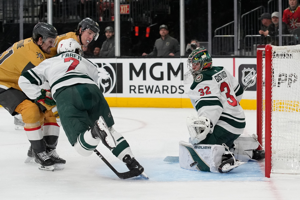 Minnesota Wild goaltender Filip Gustavsson (32) watches the puck travel by during the second period of an NHL hockey game against the Vegas Golden Knights, Monday, Dec. 29, 2025, in Las Vegas. (AP Photo/John Locher)