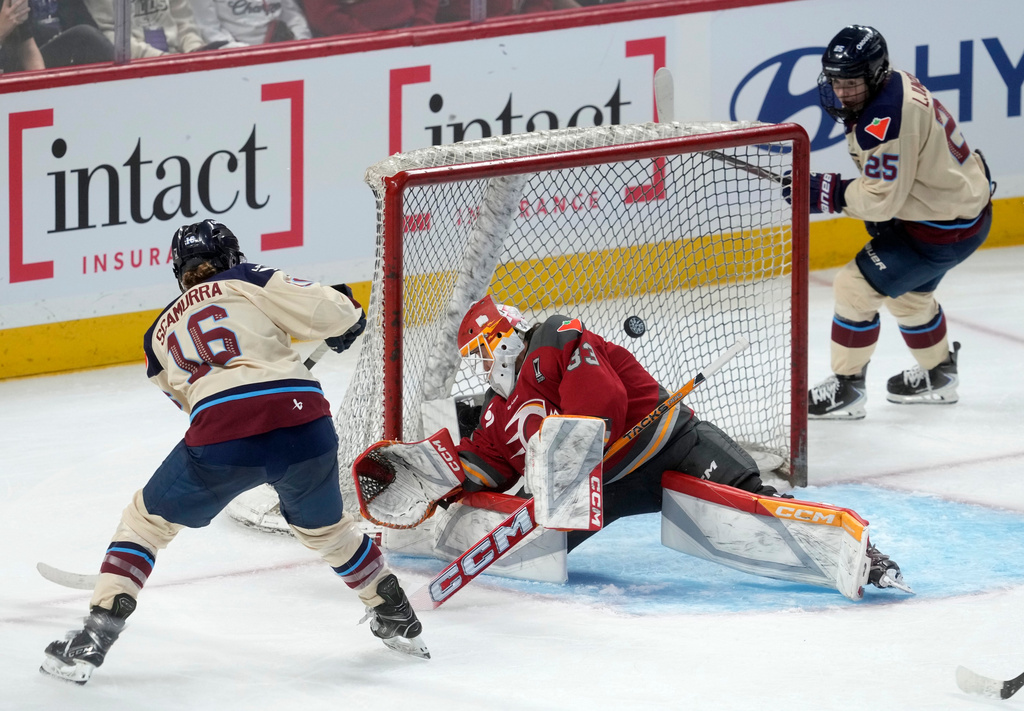 Montreal Victoire forward Hayley Scamurra (16) scores against Ottawa Charge goalie Gwyneth Philips (33) as Victoire forward Lina Ljungblom (25) watches during the third period of Game 3 in the PWHL Walter Cup finals hockey series in Ottawa, Ontario, Monday May 18, 2026. (Adrian Wyld/The Canadian Press via AP)