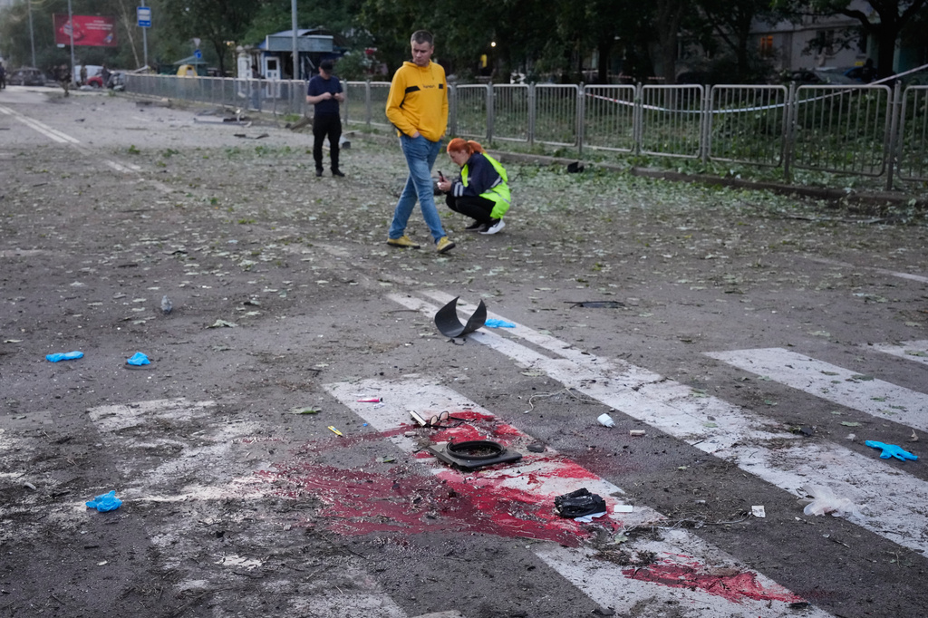 Blood and debris seen on the ground after a Russian missile attacks in Kyiv, Ukraine, Saturday, Aug. 1, 2026. (AP Photo/Efrem Lukatsky)