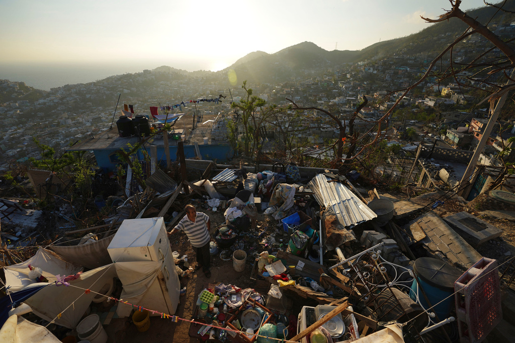 FILE - Jaime Sosa stands amid the ruins of his home nearly three weeks after Hurricane Otis hit as a Category 5 storm in the Alta Cuauhtemoc area of Acapulco, Mexico, Nov. 9, 2023. (AP Photo/Marco Ugarte, File)
