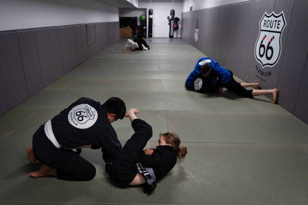 Alex Lara, left, and Rosie Diehl practice jiu-jitsu at Route 66 Jiu Jitsu Academy in Williams, Ariz., a town on the historic highway, Thursday, Nov. 20, 2025. (AP Photo/Jae C. Hong)