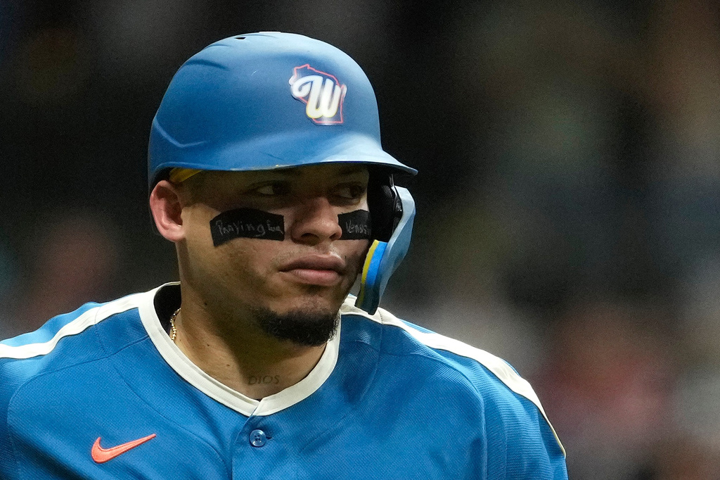 Milwaukee Brewers' William Contreras wears eye black that reads "Praying for Venezuela" as he rounds the bases after hitting a two-run home run during the seventh inning of a baseball game against the Chicago Cubs, Friday, June 26, 2026, in Milwaukee. (AP Photo/Aaron Gash)