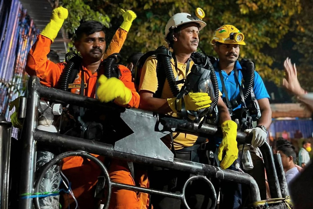 In this image provided by the Information and Public Relations Department, Government of Sikkim, rescue workers stand outside an under-construction tunnel at a hydropower project in Samardung village, about 40 kilometers (25 miles) from Gangtok, India, Wednesday, July 22, 2026. (Government of Sikkim via AP)