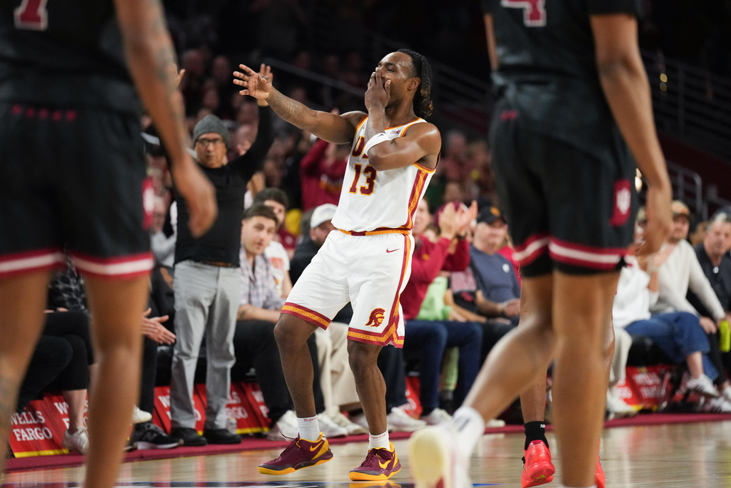Southern California guard Kam Woods (13) celebrates his three-point basket during the second half of an NCAA college basketball game against Indiana in Los Angeles, Tuesday, Feb. 3, 2026. (AP Photo/Jae C. Hong)