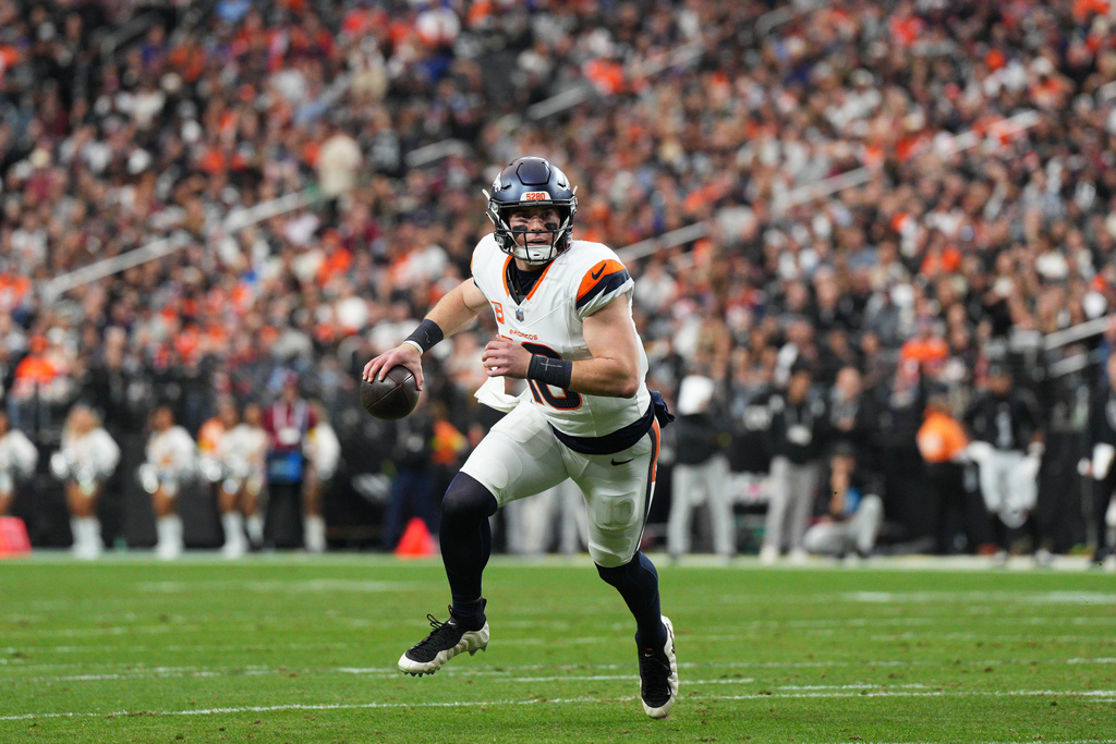 Denver Broncos quarterback Bo Nix rolls out of the pocket during the first half of an NFL football game against the Las Vegas Raiders in Las Vegas, Sunday, Dec. 7, 2025. (AP Photo/Candice Ward)